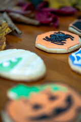 
Homemade Halloween-themed desserts. Various cakes containing the faces of different monsters of the Halloween holiday. Background containing autumn leaves.