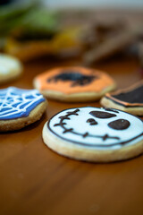 
Homemade Halloween-themed desserts. Various cakes containing the faces of different monsters of the Halloween holiday. Background containing autumn leaves.