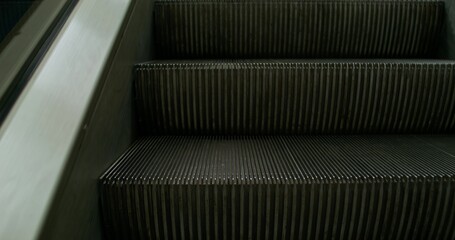 An escalator without people. Close-up of moving steps.