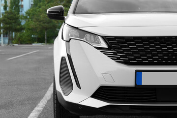 Closeup view of modern white car parked outdoors