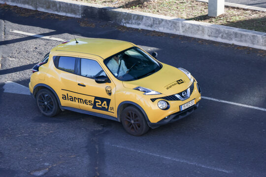 Yellow nissan juke driving on the road, company vehicle for alarmes 24 lda
