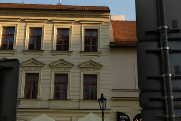 There is a prominent building in the city that features a noticeable sign displaying the letter a on its facade, which is quite eyecatching