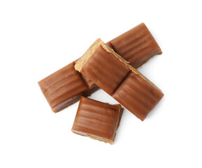 Tasty sweet caramel candies isolated on white, top view