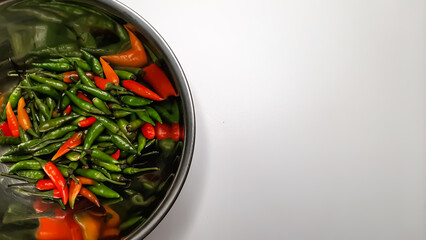 Top Edge View of Stainless Steel Bowl Filled with Fresh, Colorful Red, Orange, and Green Chili Peppers on a Clean White Background – Spicy Ingredients for Cooking, Seasoning, and Culinary Inspiration
