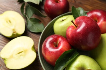 Fresh red and green apples on wooden table, closeup