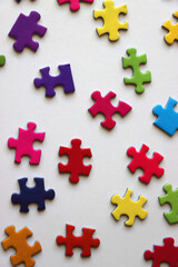 Obraz premium Colorful jigsaw puzzle pieces on white background. Flat lay.