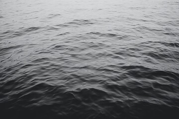 Obraz premium A close-up shot of rippling water, the surface of the ocean is a study in shades of gray.