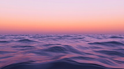 Obraz premium A calm sea at sunset, with the horizon blending into a gradient of purples and oranges, creates an atmosphere that feels serene and peaceful.