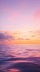 Obraz premium A calm sea at sunset, with the horizon blending into a gradient of purples and oranges, creates an atmosphere that feels serene and peaceful.
