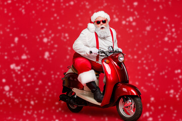 Portrait of his he nice bearded cool cheerful funky Santa hipster riding retro moped December...