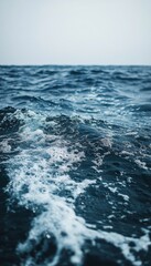 Fototapeta premium Close up view of ocean waves crashing and creating white foam.