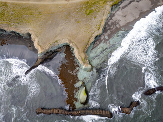 Panorama of Laekjavik beach rock formation sea stack black sand atlantic ocean coast tower east fjords Iceland Europe