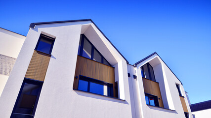 Residential homes with modern facade.Terraced family homes in newly developed housing estate. The real estate market in the suburbs. New single family houses in a new development area. 