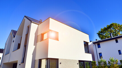 Residential homes with modern facade.Terraced family homes in newly developed housing estate. The real estate market in the suburbs. New single family houses in a new development area. 
