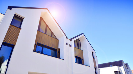 Residential homes with modern facade.Terraced family homes in newly developed housing estate. The real estate market in the suburbs. New single family houses in a new development area. 