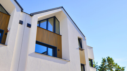 Residential homes with modern facade.Terraced family homes in newly developed housing estate. The real estate market in the suburbs. New single family houses in a new development area. 