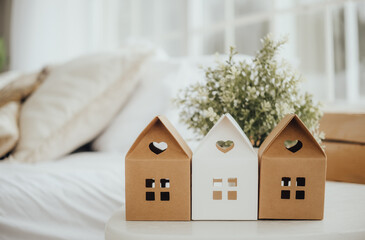 Decorative miniature houses on a table in a cozy living room setting