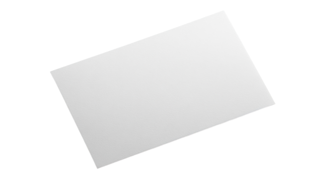 A blank canvas lies on a table, inviting creativity in a sunlit artist's studio