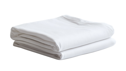 Softly folded white sheets resting neatly on a clean surface in a sunlit room