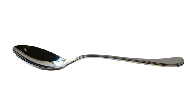 A shiny spoon resting elegantly on a white surface, reflecting soft ambient light