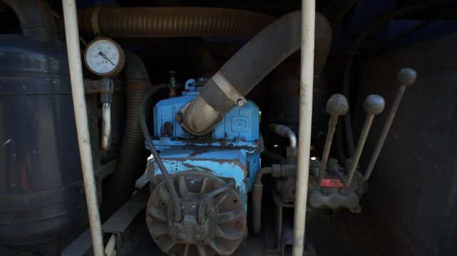 The driver of the car for sewage pumping turns on the pump with levers. High quality 4k footage