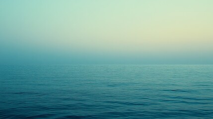 Fototapeta premium Calm Ocean Surface with Soft Blue Hues at Dusk