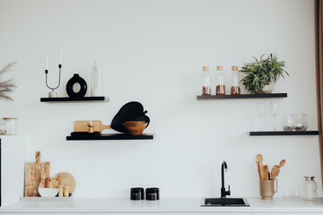 Modern kitchen shelves display minimalist decor and tableware on white