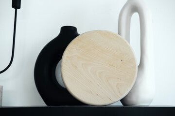 Modern decor with a round wooden table and unique vases