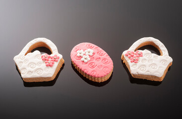Baby cookies decorated with glaze on a black background. Baby girl.