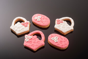 Baby cookies decorated with glaze on a black background. Baby girl.