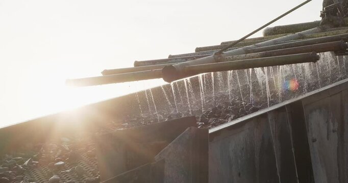 Rocks and sand move through vibrating screen. Crushing screening plant. Screening and washing in open-pit mining. Mining conveyor belt