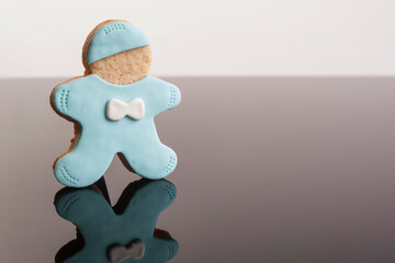 Baby cookies decorated with glaze on a black background. Baby boy.