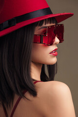 Woman, red hat, red dress, sunglasses a woman in a vibrant red dress, stylish red hat, and matching...