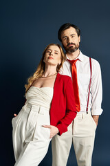 A well dressed couple stands confidently, showcasing their fashion sense and connection.