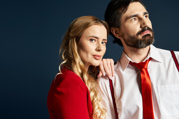 A middle aged couple stands close, showcasing elegance and charm in formal attire.