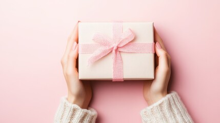 Female's hand holding a gift box