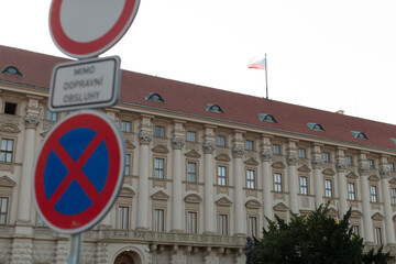 A no parking sign is prominently positioned in front of a building, clearly indicating the...