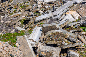 piles of old broken concrete slabs at sunny day, building rubble concept