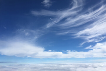Aerial image of dramatic summer white soft clouds view from aircraft window . Image use for airline travel advertising presentation background.