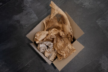 Top view of a box with bunched recyclable perforated brown paper
