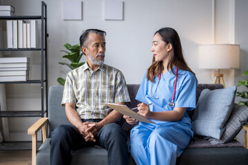 Young female doctor explaining treatment to senior male patient at home