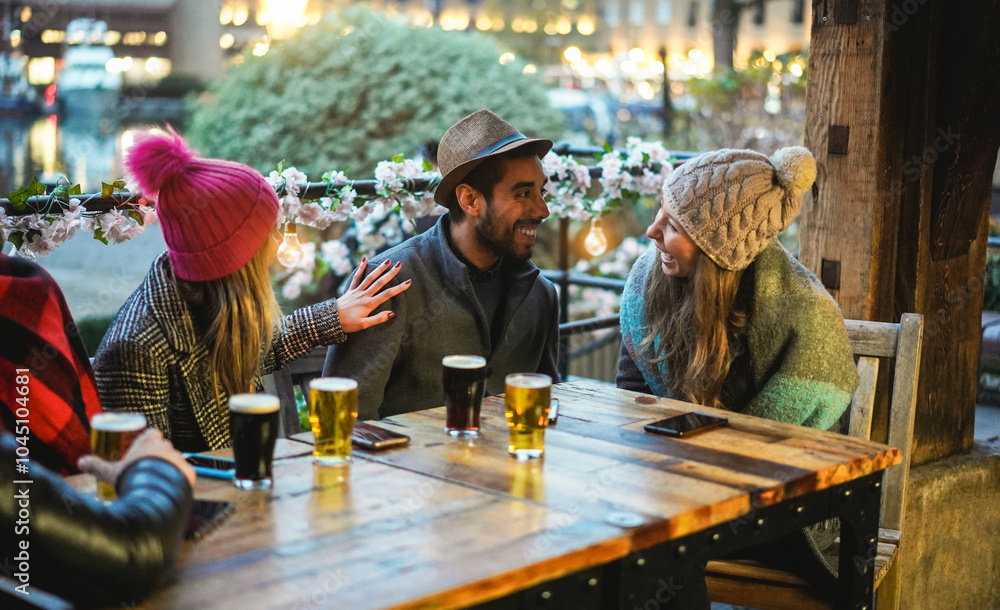 Wall mural Young friends having fun together drinking craft beers at pub restaurant - Winter lifestyle and party concept - Soft focus on man face