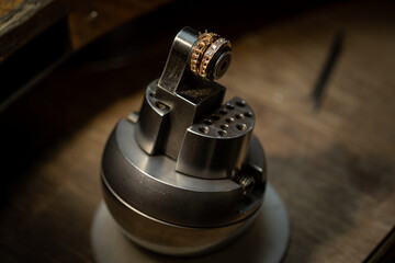 craftsman making diamond ring. hand made jewelry. Put diamond gem ring. diamond ring production craftsman workshop. solitaire ring making