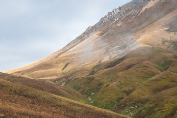 Autumn view of grass-covered slopes of the Mount Oshten in the morning light, Russian Federation
