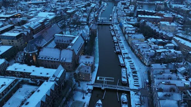 Zwolle downtown district during a cold winter morning seen from above with the rooftops a covered in a thin layer of snow.