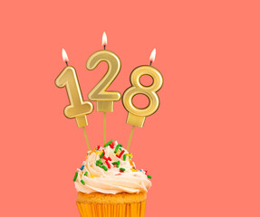 Birthday number 128 - Golden candle with cupcake