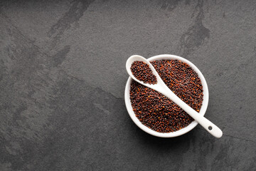 Brassica juncea - Brown mustard seeds in bowl and spoon.