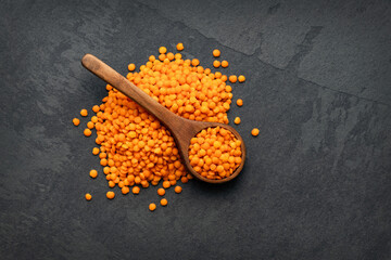 Raw red lentils on the spoon - Lens culinaris.