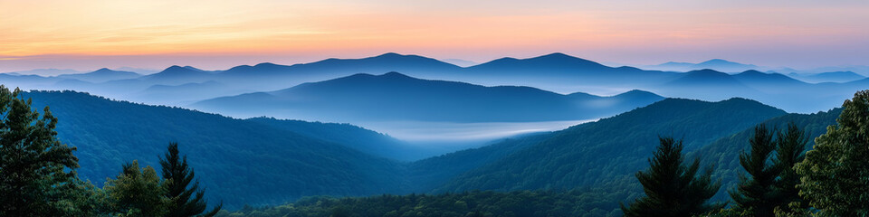Panoramic view of a majestic mountain range at sunrise with glowing peaks and vibrant sky, nature landscape background