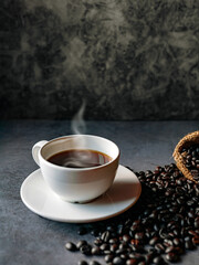 Americano coffee cup and roasted coffee beans falling in a burlap sackon gray background, Black coffee cup aromatic